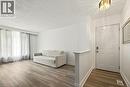Wood-finish flooring, white walls, and a paneled entry door - 27 Gretna Court, Hamilton, ON 