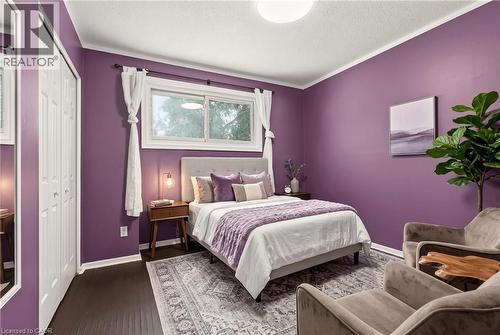 Wood-finish flooring, white bi-fold closet doors, and recessed lighting - 27 Gretna Court, Hamilton, ON 