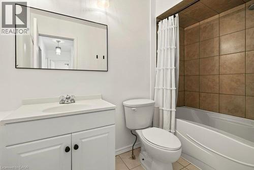 White vanity with an integrated sink, polished chrome faucet, and storage cabinetry - 27 Gretna Court, Hamilton, ON 