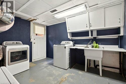 Laundry area featuring a utility sink, integrated countertop, and overhead cabinetry - 27 Gretna Court, Hamilton, ON 