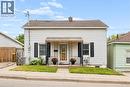 White siding exterior with a covered front porch featuring decorative metal railings - 77 Beverly Street, Cambridge, ON 