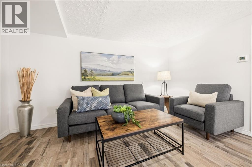 Wood-finish flooring with white walls and a textured ceiling - 77 Beverly Street, Cambridge, ON