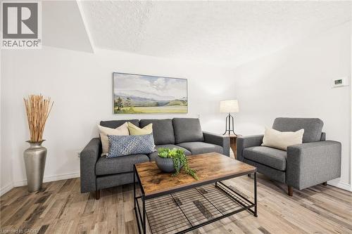 Wood-finish flooring with white walls and a textured ceiling - 77 Beverly Street, Cambridge, ON 