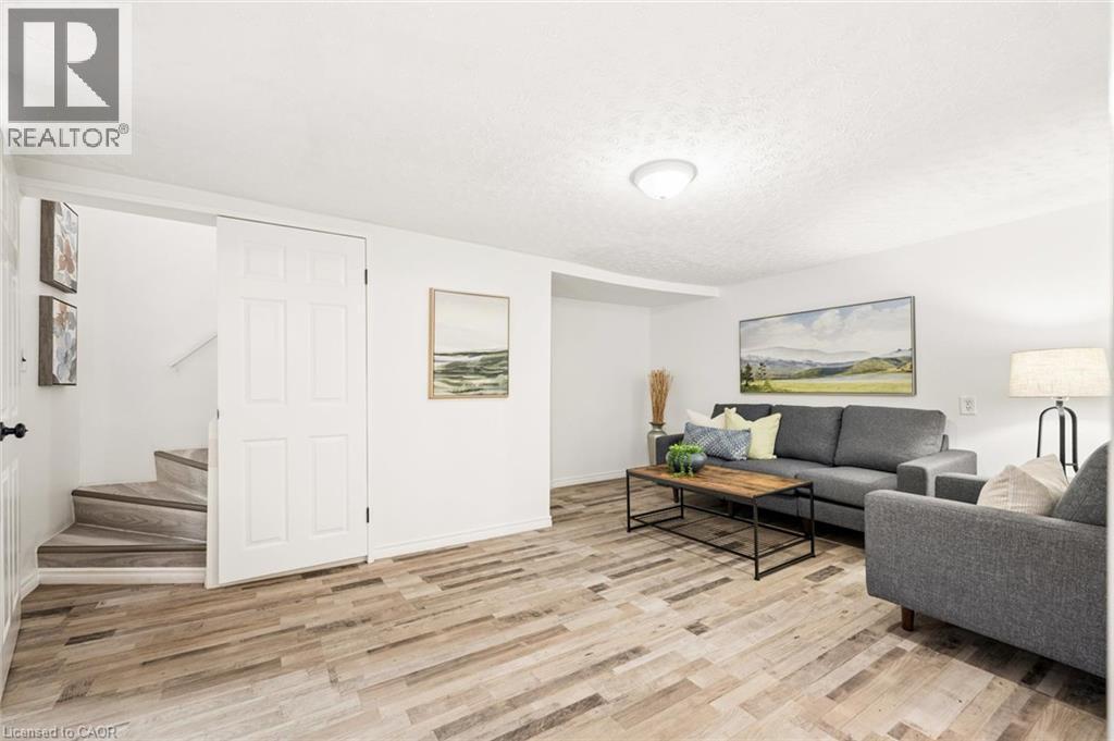 Wood-finish flooring, white walls, and a staircase with wood-finish treads - 77 Beverly Street, Cambridge, ON