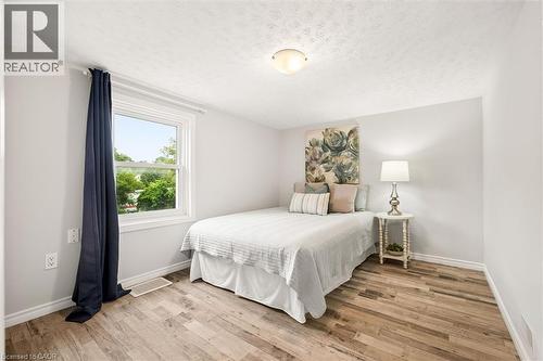 Recessed window with white trim, wood-finish flooring, white walls, and an overhead flush-mount light fixture - 77 Beverly Street, Cambridge, ON 