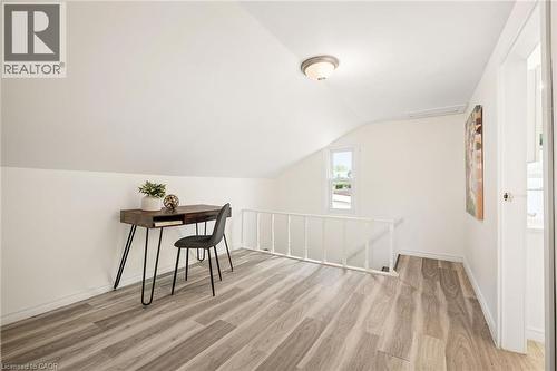Sloped ceilings, wood-finish flooring, white walls, and a recessed window - 77 Beverly Street, Cambridge, ON 