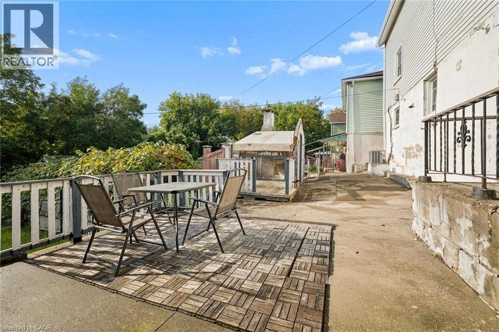 Outdoor deck with wood-finish tile accents and painted railing - 77 Beverly Street, Cambridge, ON