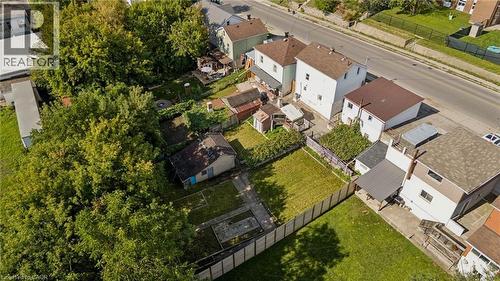 Expansive property with mature trees, a manicured lawn, and a perimeter fence - 77 Beverly Street, Cambridge, ON 
