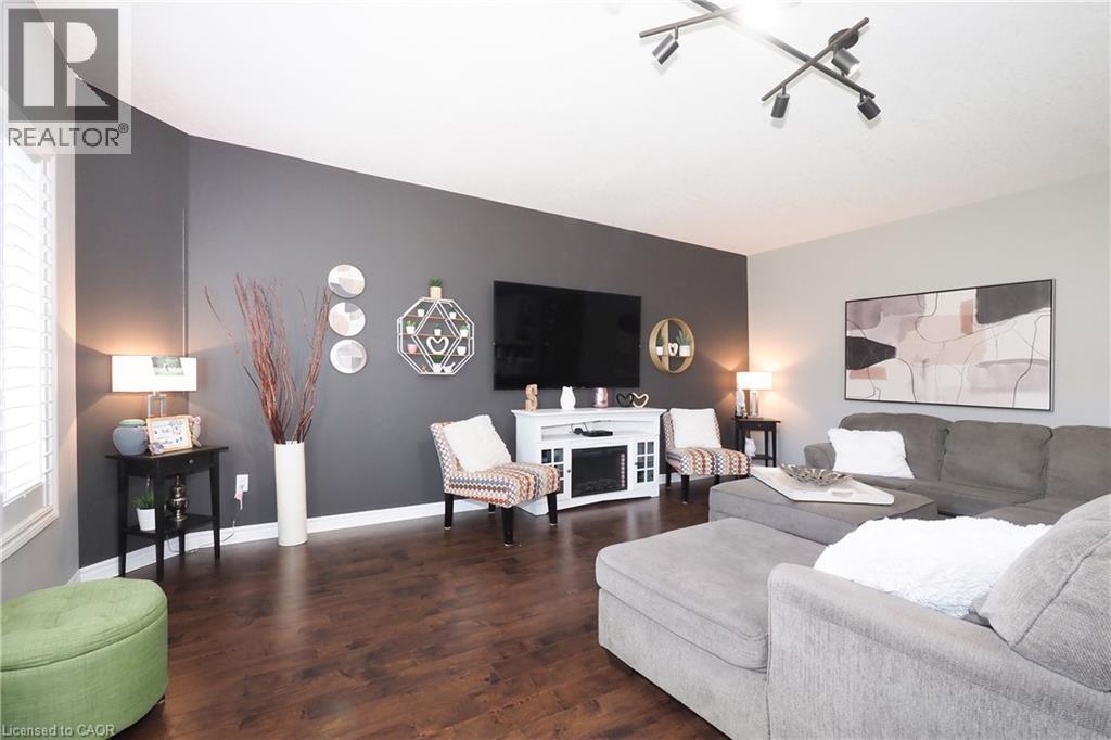 Dark wood-finish flooring, white window shutters, and a track lighting fixture - 1200 Dunbar Road, Cambridge, ON