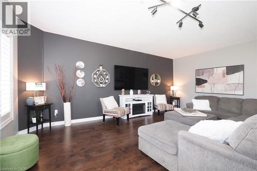 Dark wood-finish flooring, white window shutters, and a track lighting fixture - 1200 Dunbar Road, Cambridge, ON 