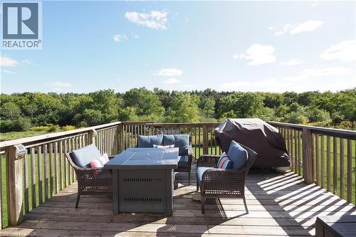Wood-finish deck with vertical railing and natural surroundings - 1200 Dunbar Road, Cambridge, ON 