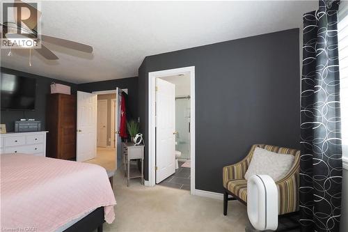 Ceiling fan with integrated lighting, dark accent wall, interior door, light-colored carpeting, window with blinds - 1200 Dunbar Road, Cambridge, ON 
