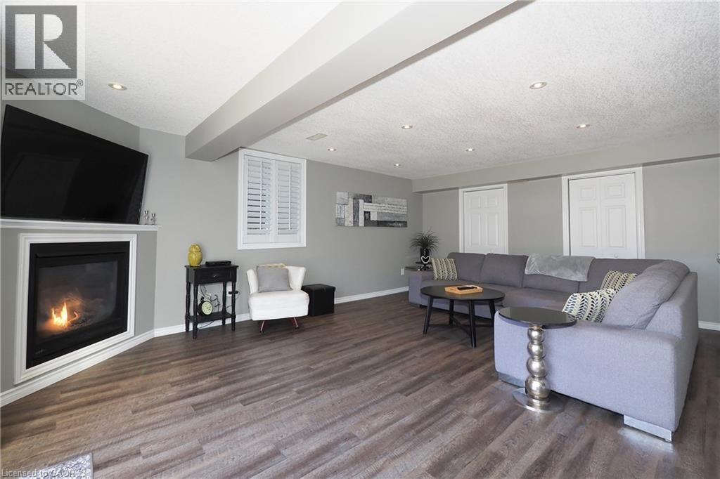 Hardwood-finish flooring, recessed lighting, and a built-in fireplace with a white mantel and trim - 1200 Dunbar Road, Cambridge, ON