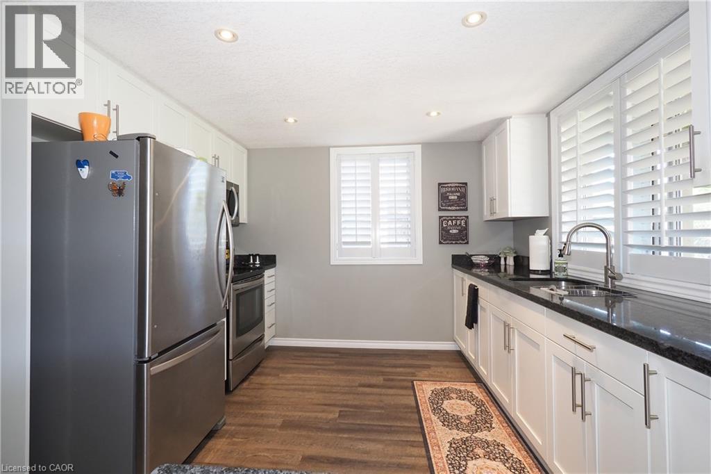 Recessed lighting illuminating the kitchen with wood-finish flooring - 1200 Dunbar Road, Cambridge, ON