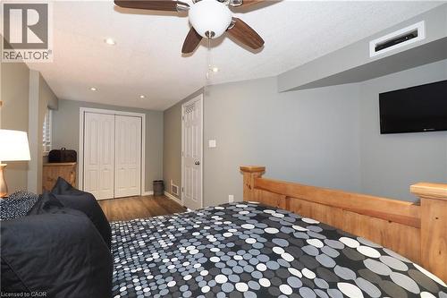 Wood-finish flooring, recessed lighting, ceiling fan, and white bi-fold closet doors - 1200 Dunbar Road, Cambridge, ON 