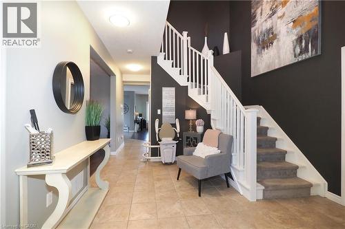 Tiled flooring, white staircase railing, and recessed lighting - 1200 Dunbar Road, Cambridge, ON 