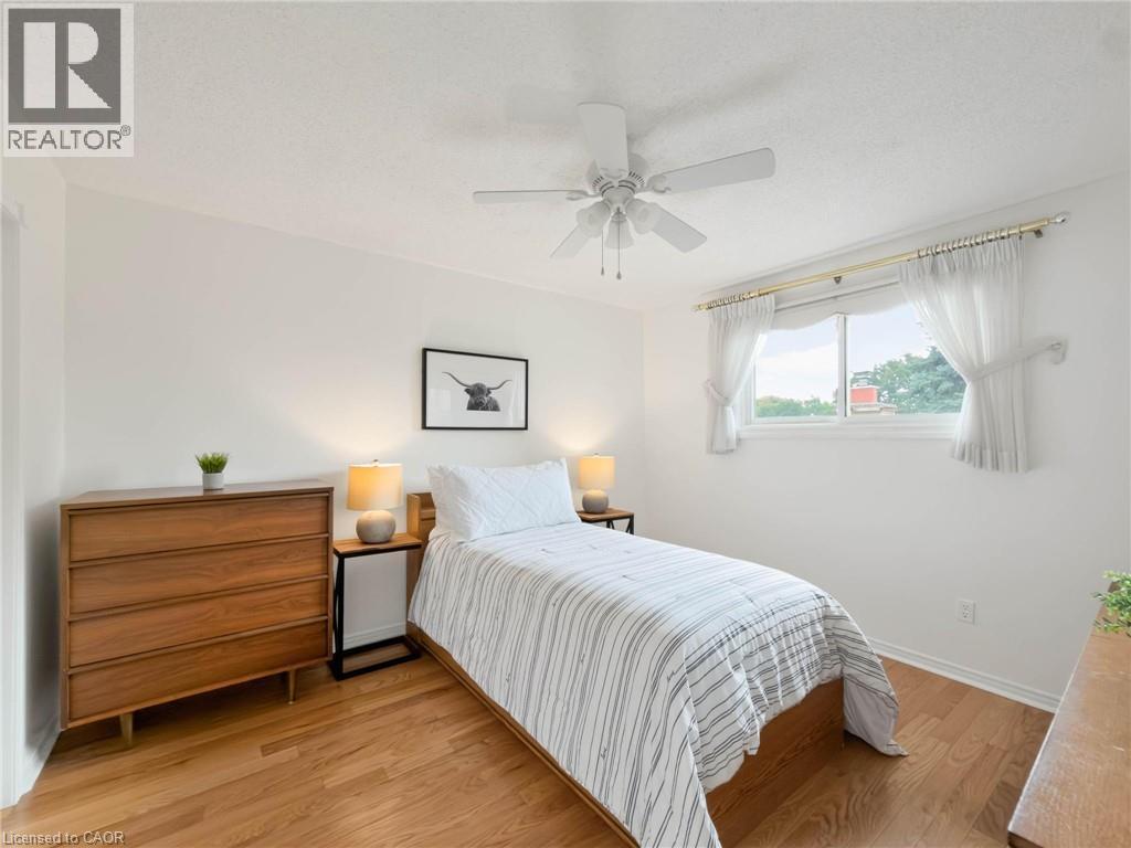 Hardwood flooring, white walls, and a ceiling fan with integrated lighting - 1236 Thorpe Road, Burlington, ON