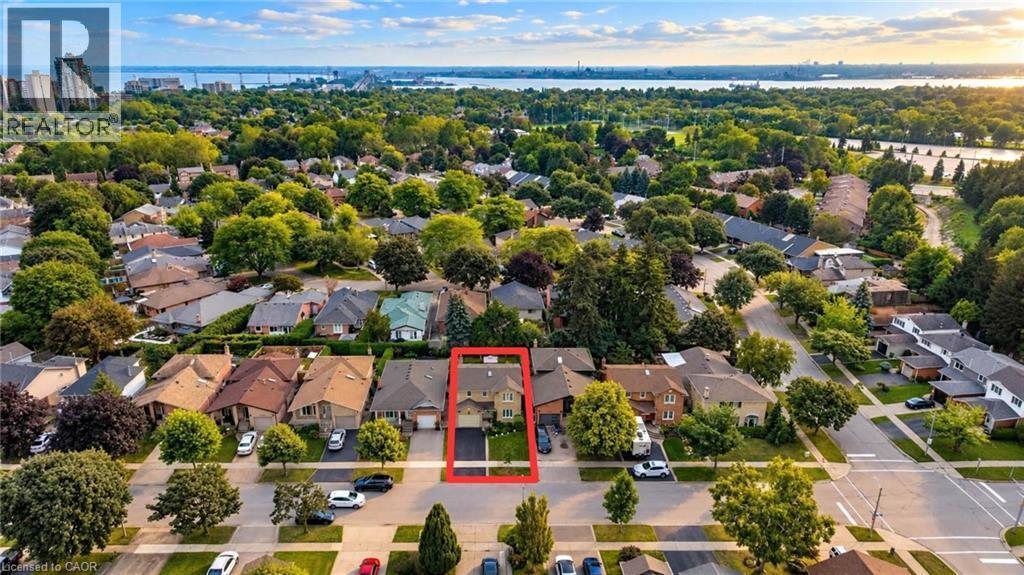 Aerial perspective of a residential neighborhood featuring mature trees and a distant body of water - 1236 Thorpe Road, Burlington, ON