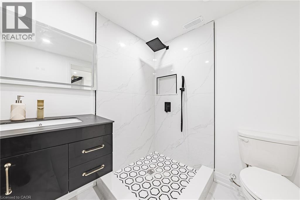Spacious shower with hex-tile flooring and a built-in niche - 4511 Guelph Line, Burlington, ON