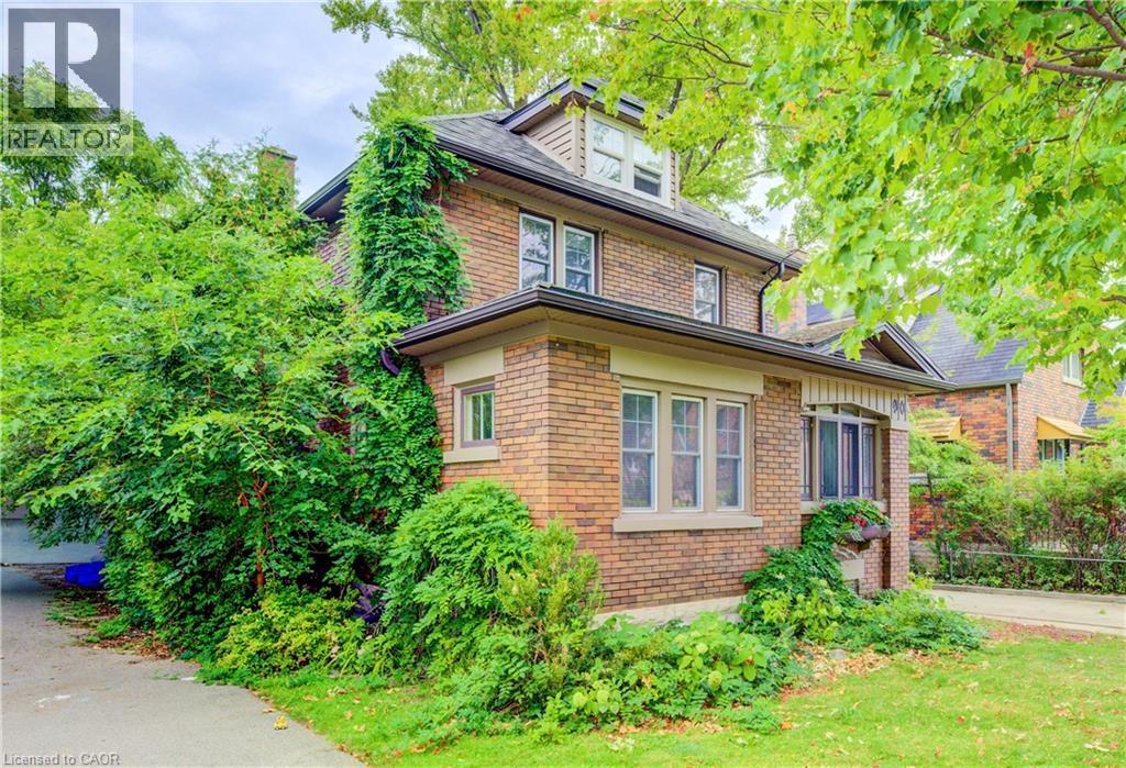 Brick exterior with dormer window, multiple pane windows, and established landscaping - 90 Brock Street, Kitchener, ON