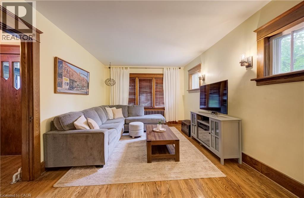 Wood-finish flooring throughout, complemented by wood trim and window frames - 90 Brock Street, Kitchener, ON