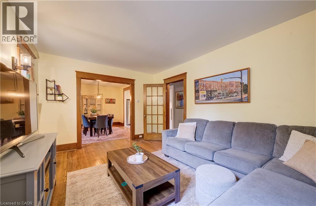 Wood-finish flooring throughout, with a wide cased opening to the dining area - 90 Brock Street, Kitchener, ON