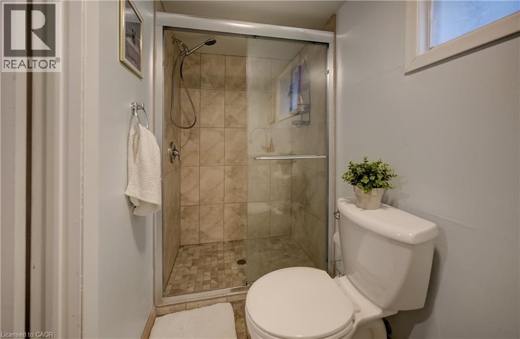 Glass-enclosed shower with tiled walls and floor - 90 Brock Street, Kitchener, ON