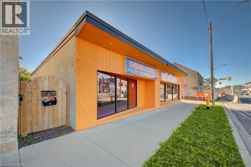 Commercial storefront with large display windows, painted brick exterior, and a flat roof - 1118 King Street E, Cambridge, ON