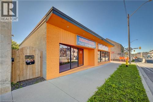 Commercial storefront with large display windows, painted brick exterior, and a flat roof - 1118 King Street E, Cambridge, ON 