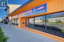 Exterior commercial facade featuring large display windows, a prominent entrance, and a wide sidewalk - 1118 King Street E, Cambridge, ON 