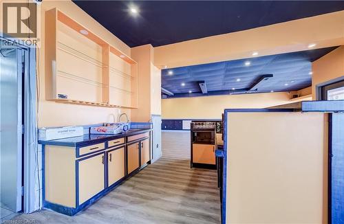 Built-in lower cabinetry with a sink, overhead shelving, recessed lighting, and wood-finish flooring - 1118 King Street E, Cambridge, ON 