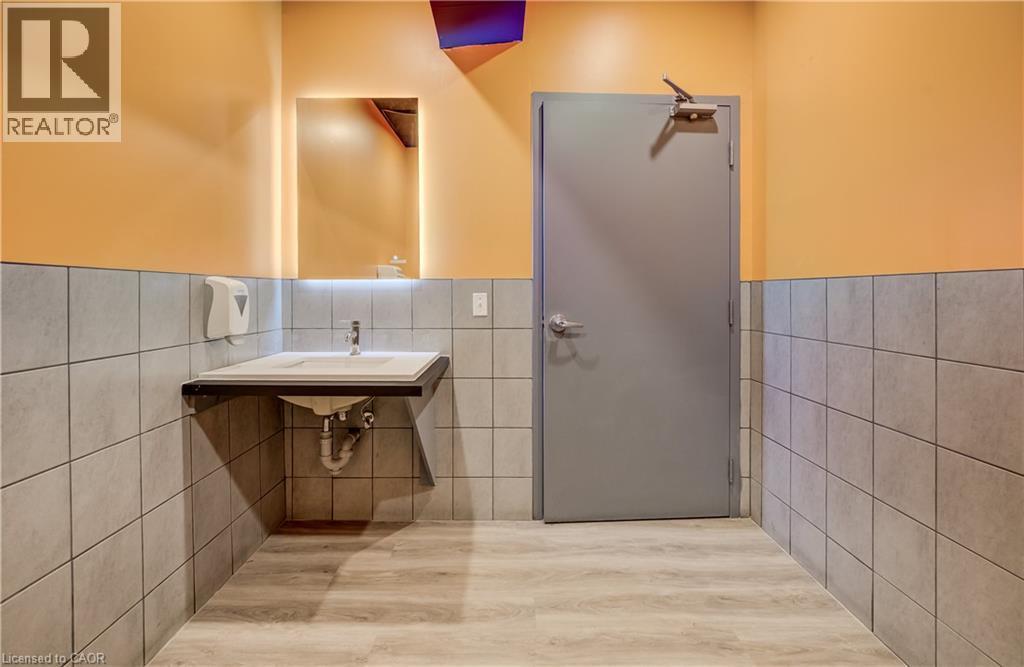 Wall-mounted vanity with a rectangular basin sink and a single-handle faucet - 1118 King Street E, Cambridge, ON
