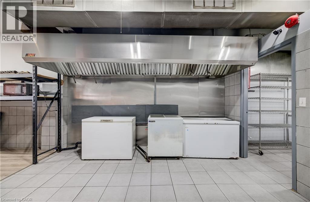 Commercial-grade stainless steel exhaust hood, tile flooring, and wall tiling - 1118 King Street E, Cambridge, ON