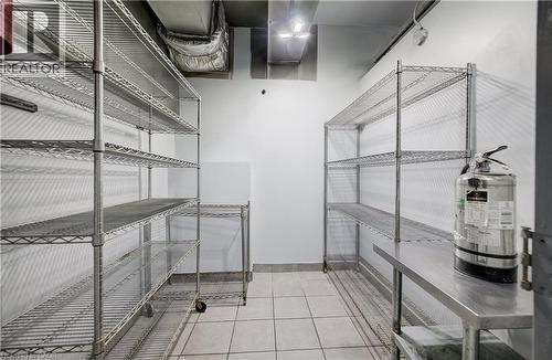 Wire shelving units, tiled flooring, stainless steel countertop, and overhead ductwork - 1118 King Street E, Cambridge, ON 