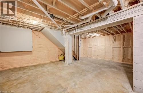 Unfinished lower level featuring exposed ceiling joists, concrete flooring, and spray foam insulation - 1118 King Street E, Cambridge, ON 