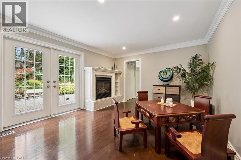 Hardwood flooring, crown molding, double French doors, built-in fireplace with a mantel, and recessed lighting - 334 Coleridge Drive, Waterloo, ON