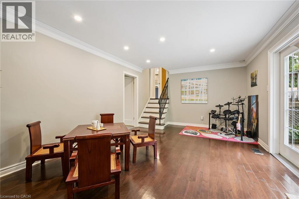 Hardwood flooring, recessed lighting, crown molding, double French doors, and a staircase with wrought iron balusters - 334 Coleridge Drive, Waterloo, ON