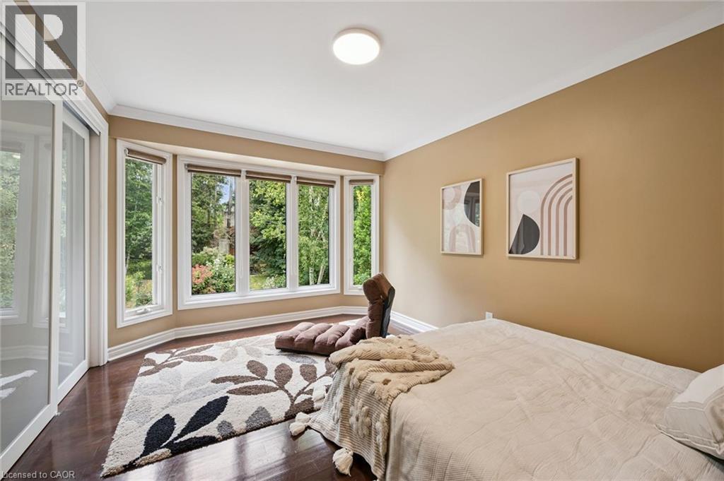 Bay window with multiple glass panes, wood-finish flooring, white crown molding, light-colored walls, and a ceiling-mounted light fixture - 334 Coleridge Drive, Waterloo, ON