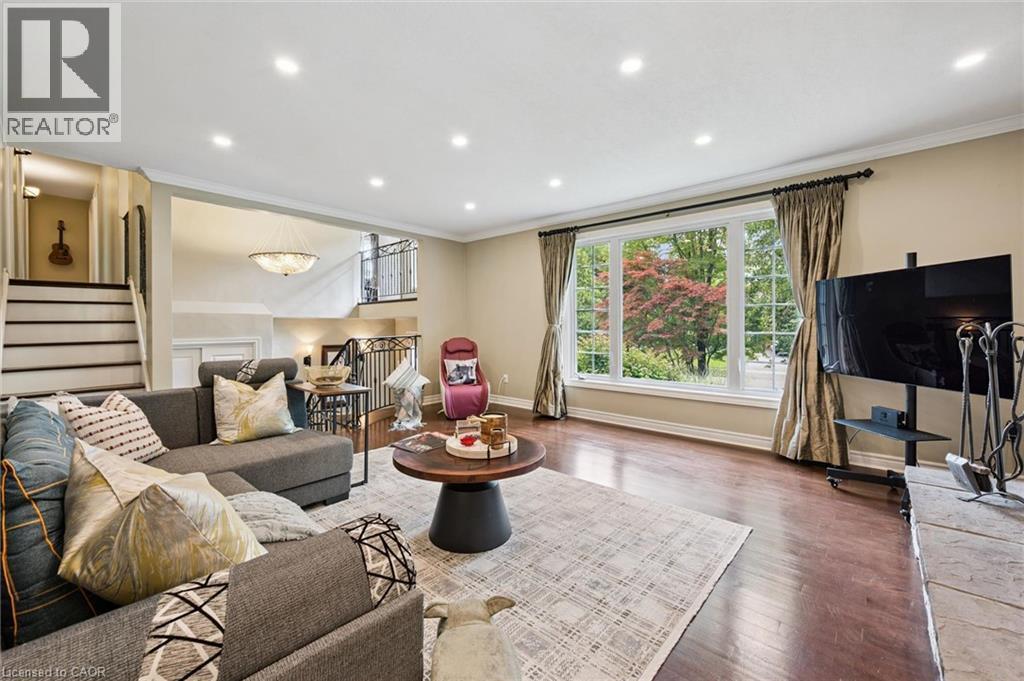 Hardwood-style flooring, large picture window, recessed lighting, and crown molding - 334 Coleridge Drive, Waterloo, ON