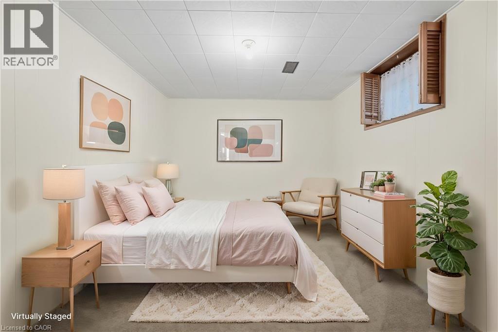 Recessed window with wood shutters, neutral wall paneling, and ceiling tiles - 137 Picton Street E, Hamilton, ON