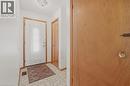 Entryway featuring tile flooring, a white entry door with a decorative glass insert, and natural wood-finish trim - 137 Picton Street E, Hamilton, ON 