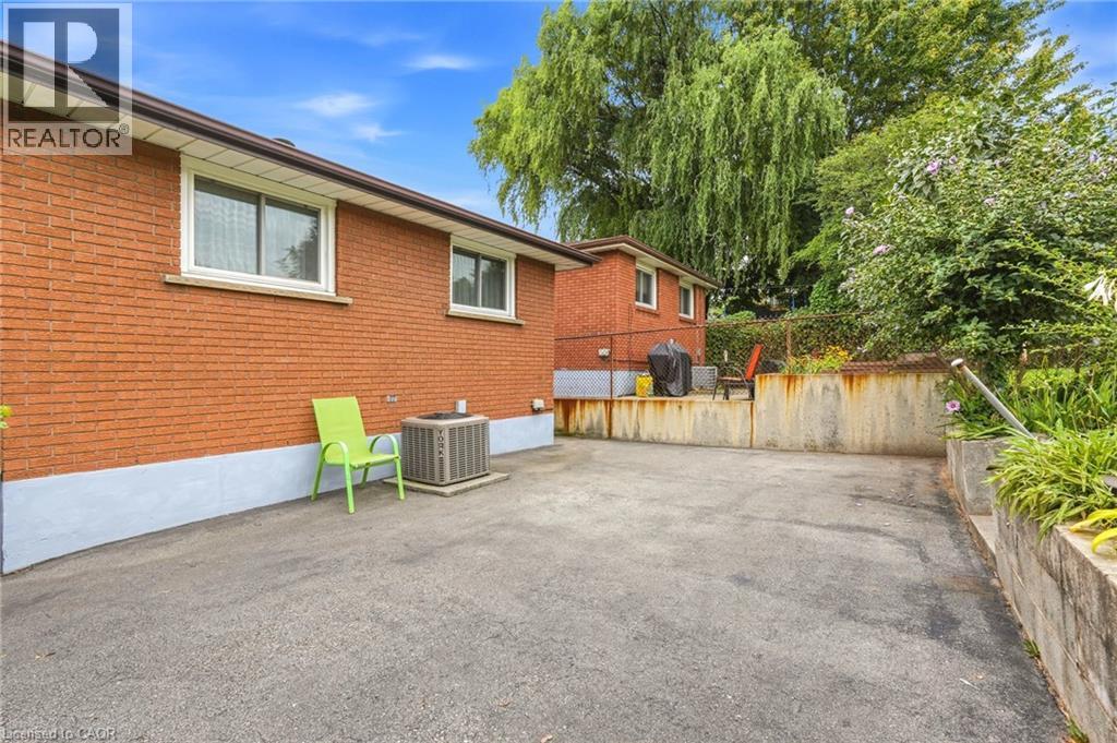 Brick exterior with white-framed windows - 137 Picton Street E, Hamilton, ON