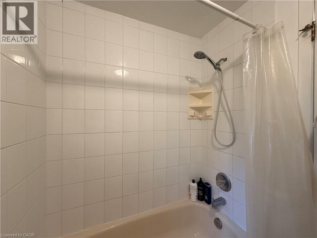 White tiled shower surround with an integrated bathtub - 450 Bridge Street W, Waterloo, ON