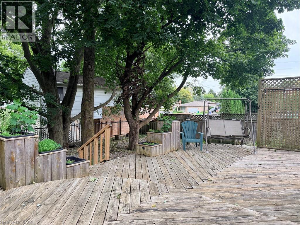Multi-level wood deck featuring built-in planters and wood lattice privacy screening - 450 Bridge Street W, Waterloo, ON