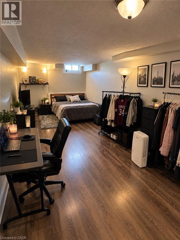 Wood-finish flooring throughout, recessed lighting, and a window providing natural light - 125 Fairgreen Close, Cambridge, ON