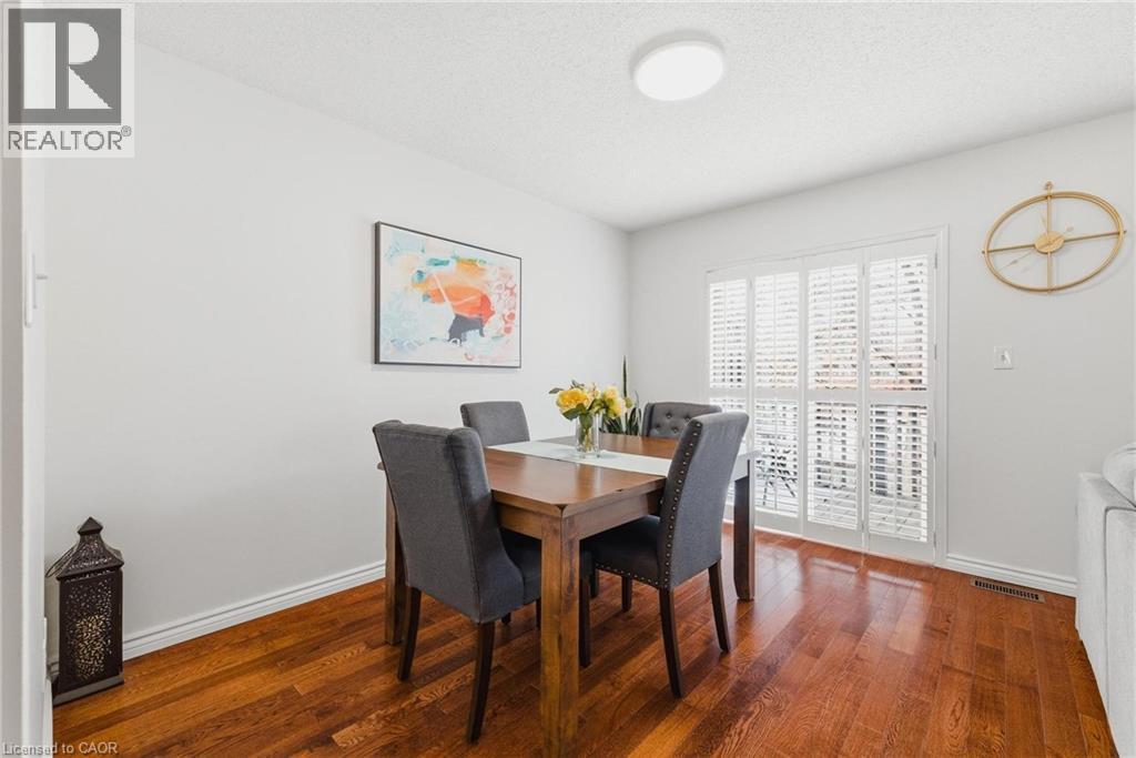 Hardwood-finish flooring enhancing a dining area with white baseboards and light gray walls - 245 Bishop Street S Unit# 31, Cambridge, ON