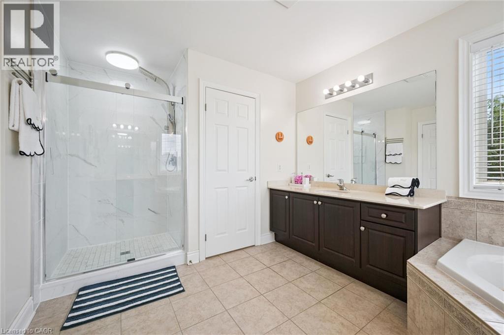 Walk-in shower with clear glass enclosure and tile surround - 517 Topper Woods Crescent, Kitchener, ON