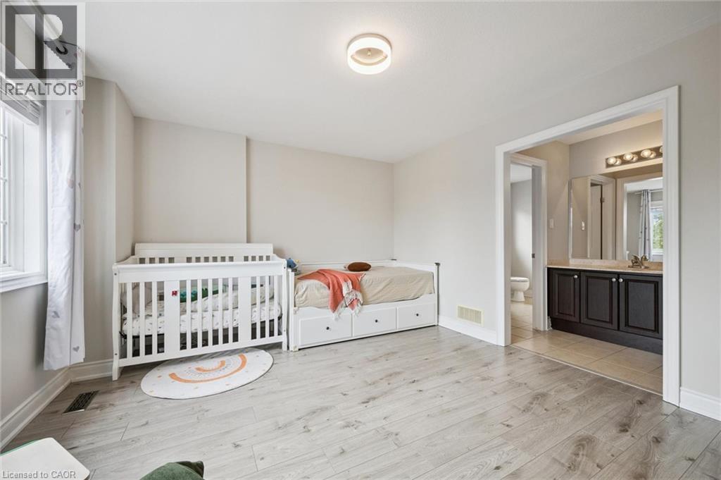 Light wood-finish flooring, neutral wall tones, and recessed lighting - 517 Topper Woods Crescent, Kitchener, ON