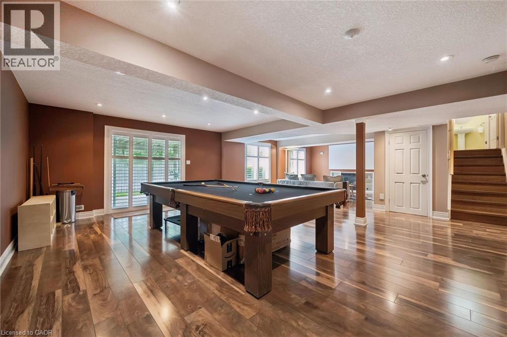Wood-finish flooring throughout, recessed lighting, and a white paneled door - 517 Topper Woods Crescent, Kitchener, ON
