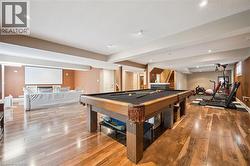 Expansive lower level featuring wood-finish flooring, recessed lighting, and a built-in projection screen -